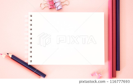 Template. Pink background with pencils.The image shows Free Space For Text on a notebook on pink background. Bright picture. Concept Image 116777693