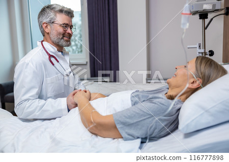 Doctor talking to a patient and holding her hands Doctor talking to a patient and holding her hands 116777898