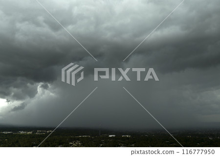 Stormy cumulonimbus clouds forming before thunderstorm on dark sky. Moving and changing cloudscape weather 116777950