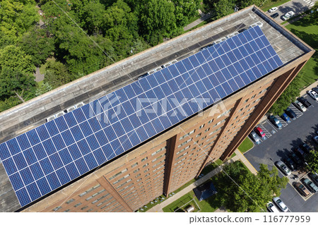 Solar photovoltaic panels installed on top of residential condo building for producing clean ecological electric energy. Renewable electricity with zero emission concept 116777959