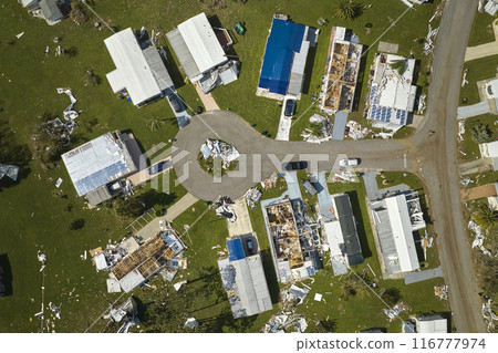 Severely damaged houses after hurricane Ian in Florida mobile home residential area. Consequences of natural disaster Severely damaged houses after hurricane Ian in Florida mobile home residential area. Consequences of natural disaster 116777974