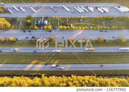 Rest area for semi trucks near busy interstate freeway. Truck stop place during hauling cargo Rest area for semi trucks near busy interstate freeway. Truck stop place during hauling cargo 116777992