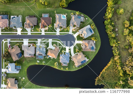 Residential homes in suburban sprawl development in North Port, Florida. Low-density private houses in rural suburbs. Housing market in the USA Residential homes in suburban sprawl development in North Port, Florida. Low-density private houses in rural suburbs. Housing market in the USA 116777998