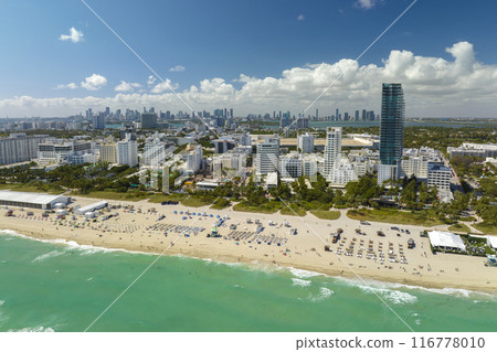 Popular vacation spot in the United States. Ocean warm waters and sandy beachfront at Miami Beach in Florida, USA. American travel destination Popular vacation spot in the United States. Ocean warm waters and sandy beachfront at Miami Beach in Florida, USA. American travel destination 116778010