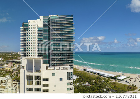 Popular vacation spot in the United States. Ocean warm waters and sandy beachfront at Miami Beach in Florida, USA. American travel destination Popular vacation spot in the United States. Ocean warm waters and sandy beachfront at Miami Beach in Florida, USA. American travel destination 116778011