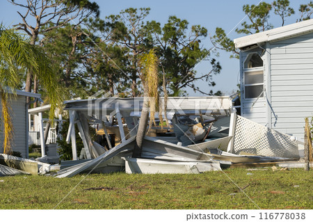 Natural disaster consequences. Severely damaged by hurricane mobile homes in Florida residential area 116778038