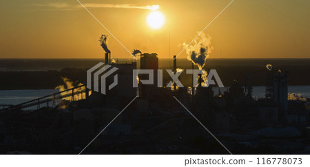 Large factory structure with smoke from production process risin Large factory structure with smoke from production process risin 116778073