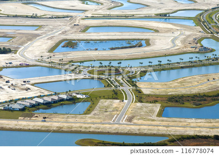 Large development area of residential housing. New suburbs ready for house construction on prepared soil in Florida. Real estate market in the USA 116778074