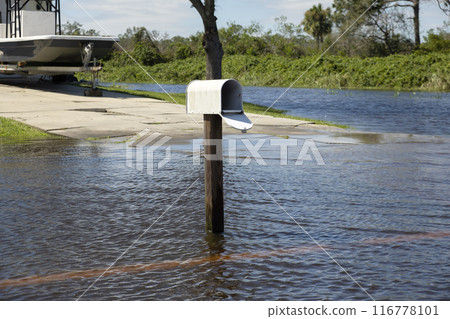 Hurricane flooded street with mail box surrounded with water in Florida residential area. Consequences of natural disaster Hurricane flooded street with mail box surrounded with water in Florida residential area. Consequences of natural disaster 116778101