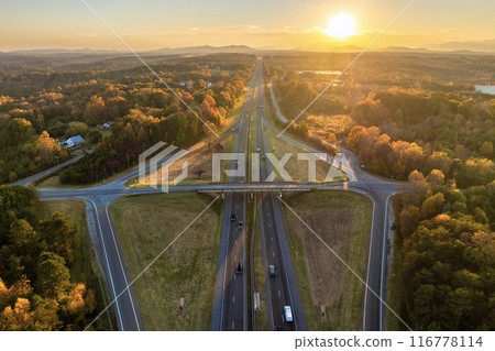 Highway intersection in American rural area. Elevated interchange lanes for express passing of car traffic Highway intersection in American rural area. Elevated interchange lanes for express passing of car traffic 116778114