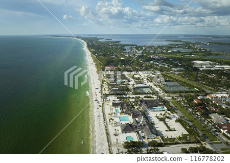 View from above of large residential homes in island small town Boca Grande on Gasparilla Island in southwest Florida. American waterfront houses in rural US suburbs View from above of large residential homes in island small town Boca Grande on Gasparilla Island in southwest Florida. American waterfront houses in rural US suburbs 116778202