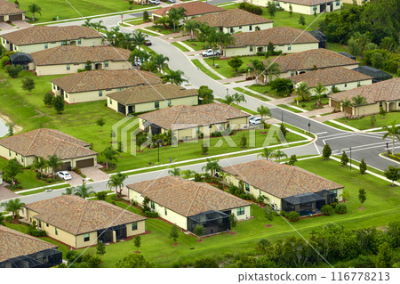 View from above of densely built residential houses in closed living clubs in south Florida. American dream homes as example of real estate development in US suburbs 116778213