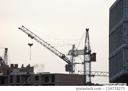 Tower cranes at high residential apartment buildings construction site. Real estate development 116778275