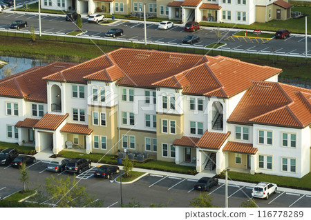 Top view of new apartment condos in Florida suburban area. Family housing in quiet neighborhood. Real estate development in american suburbs 116778289