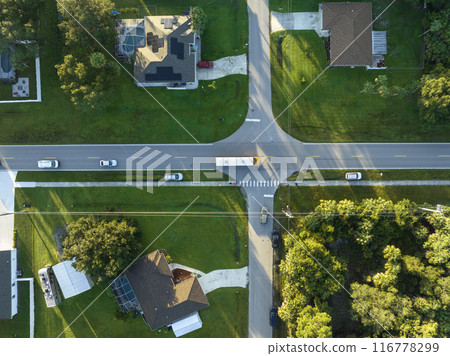 Top view of classical american yellow school bus driving on rural town street for picking up kids for their lessongs in early morning. Public transport in the USA 116778299