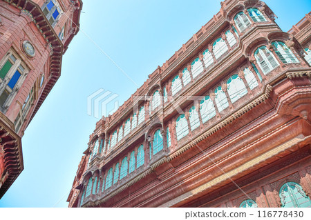 Dulmera Havelis in Bikaner with windows in green tones and touristy red facades Dulmera Havelis in Bikaner with windows in green tones and touristy red facades 116778430