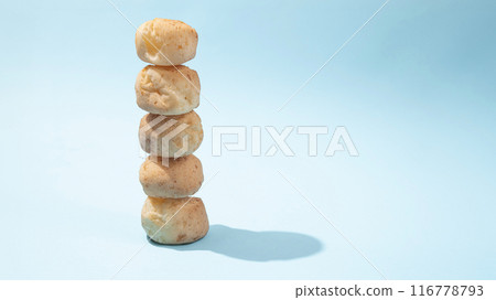 cheese bread - pao de queijo stacked on top of each other like a tower cheese bread - pao de queijo stacked on top of each other like a tower 116778793