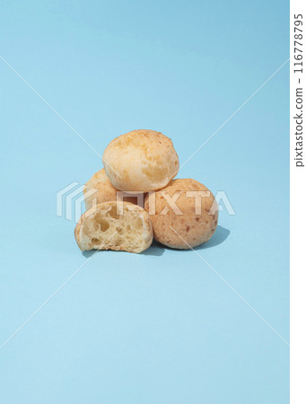 Brazilian cheese breads on the blue background Brazilian cheese breads on the blue background 116778795