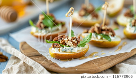 Pear and Pecan Appetizers on Wooden Board Pear and Pecan Appetizers on Wooden Board 116778906