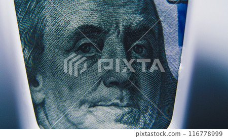 Hundred dollar banknote lying in paper money counting machine Hundred dollar banknote lying in paper money counting machine 116778999