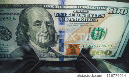 Close up of bill counter machine counting hundred dollar banknotes 116779014