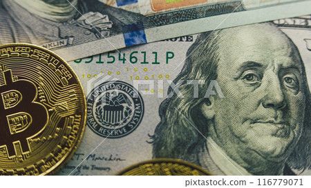 Golden bitcoin coins and hundred dollar bills 116779071