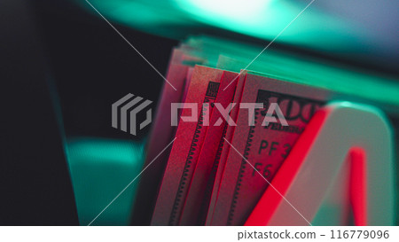 Close up of bill counter machine counting hundred dollar bills 116779096