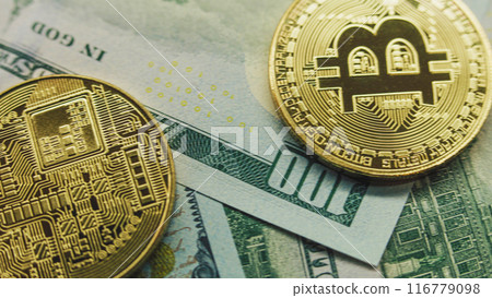 Golden bitcoin coins and hundred dollar bills 116779098