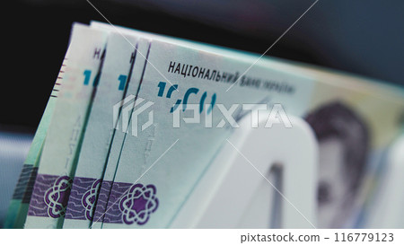 Close up of money counting machine counting thousand of hryvnia bills 116779123