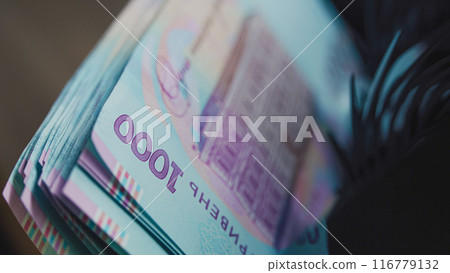 Cash counting machine counts thousand of hryvnia bills 116779132