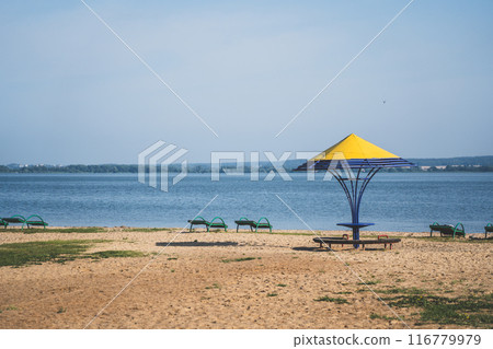 Gazebos with a yellow dome on the beach by the lake Gazebos with a yellow dome on the beach by the lake 116779979