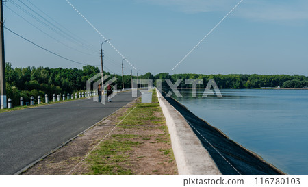People walking along the road along the embankment People walking along the road along the embankment 116780103