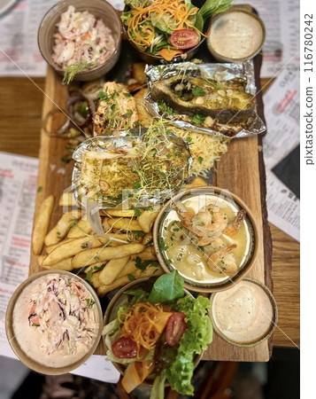 Seafood platter in a restaurant on a wooden board 116780242