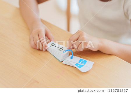 Elementary school student studying math for summer vacation homework 116781237