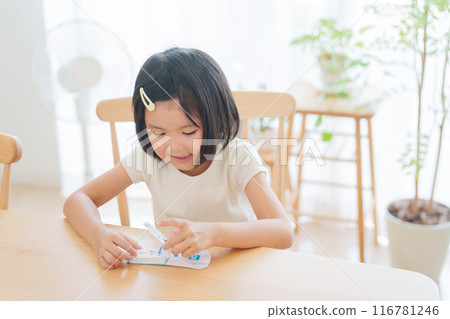 Elementary school student studying math for summer vacation homework Elementary school student studying math for summer vacation homework 116781246