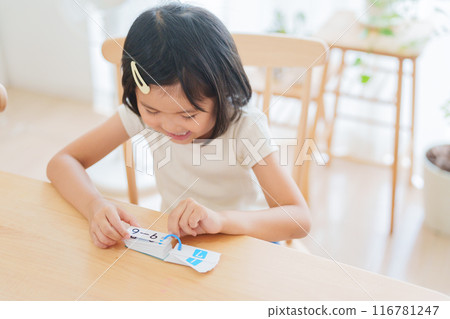Elementary school student studying math for summer vacation homework Elementary school student studying math for summer vacation homework 116781247