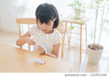 Elementary school student studying math for summer vacation homework Elementary school student studying math for summer vacation homework 116781249