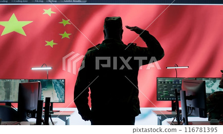 Chinese military officer in uniform monitors critical data on big screen. The national flag is presented in the army operations room, military command center used for propaganda. Camera A. Chinese military officer in uniform monitors critical data on big screen. The national flag is presented in the army operations room, military command center used for propaganda. Camera A. 116781395