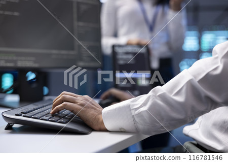 IT specialist ensuring server farm systems provide redundancy, automatic failover and rapid reconfiguration of clusters to minimize failure of individual machines, close up shot 116781546
