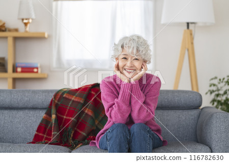 Senior woman looking at camera and smiling Senior woman looking at camera and smiling 116782630