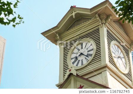 A clock tower in Hokkaido surrounded by trees A clock tower in Hokkaido surrounded by trees 116782745