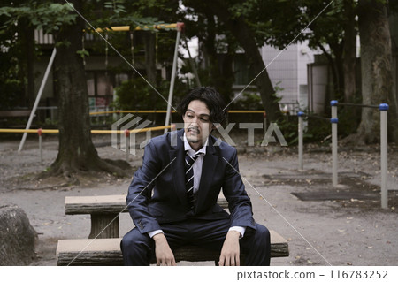 Man sitting outdoors 116783252