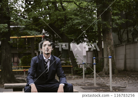Man sitting outdoors 116783256