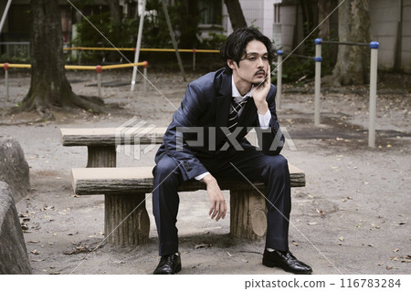 Man sitting outdoors 116783284