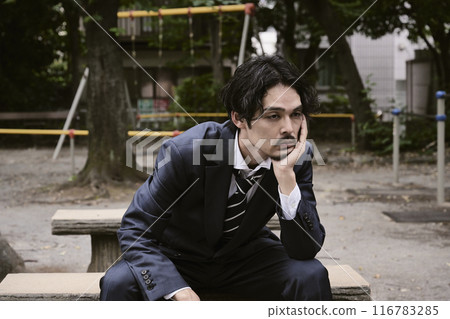 Man sitting outdoors 116783285