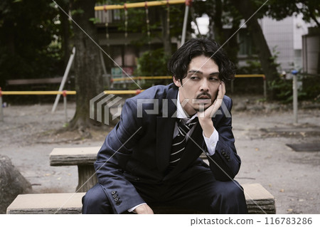 Man sitting outdoors 116783286