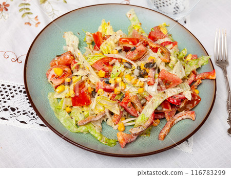 On plate, portion is laid out with pim salad of corn, cabbage, mayonnaise. On plate, portion is laid out with pim salad of corn, cabbage, mayonnaise. 116783299