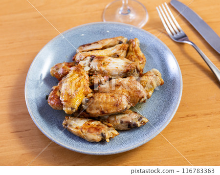 Portion of appetizing fried chicken wings Portion of appetizing fried chicken wings 116783363