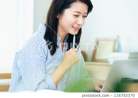 A woman working on a computer 116783370