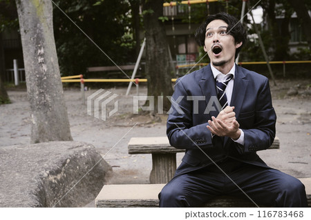 Man sitting outdoors Man sitting outdoors 116783468